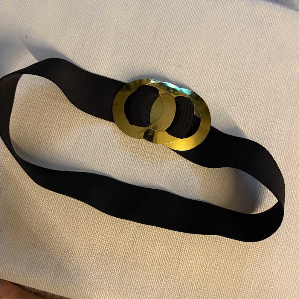 80s black stretch belt with a gold-tone interlocking ring buckle